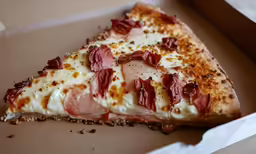 the pizza is topped with meat and cheese