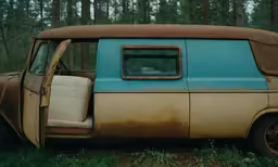 an old rusted up van sitting in a field