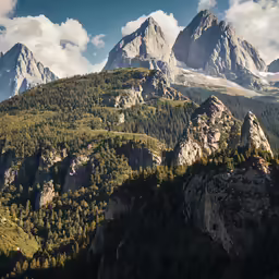 a mountainous valley with mountains and trees on the hillside