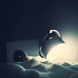 a white light that is on top of a bed
