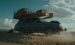 the truck is traveling down a dusty road