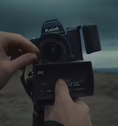 the person is holding up their camera to take the photo