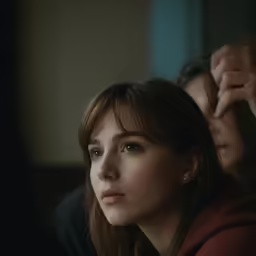 a woman is brushing her hair next to another women