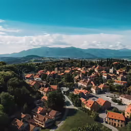 a town surrounded by mountains under a blue sky