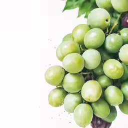 some green grapes with leafy leaves on them