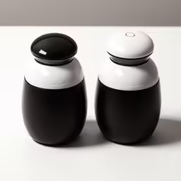two black and white containers that are on a table