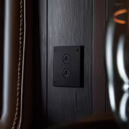 an old - fashioned speaker is mounted on a wood panel wall