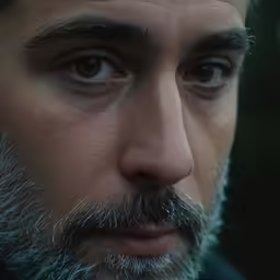 a man wearing a jacket looking towards the camera