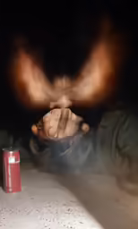 a woman eating something while holding her hand up