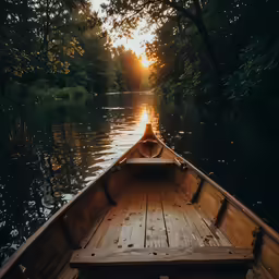 the back end of a canoe sailing down a river
