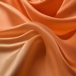 a plain, orange - colored fabric with very slight folds