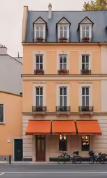 an image of a hotel building with orange awnings