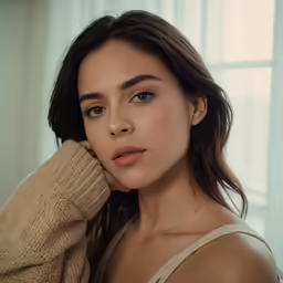 an attractive young woman with short hair wearing a sweater