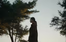 the man standing by himself is looking to his left