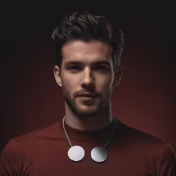 a man posing with two circular necklaces on his neck
