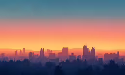 the silhouette of a city and the horizon, as seen at sunset