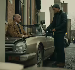 a man getting his car for sale by another man