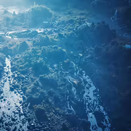 the aerial view of a river running through grass