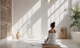 a woman is sitting on the floor watching her phone