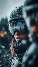 a woman wearing goggles and standing in snow