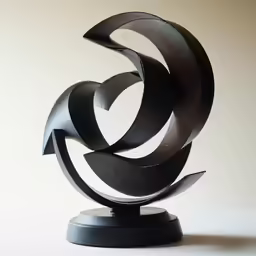 a metal sculpture with a circular black pattern on it