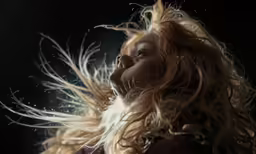 a woman with her hair in the wind