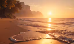 the sun rises over a beach near an ocean