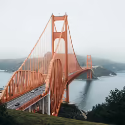 the view from above a bridge of a lake and mountains
