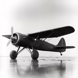 the small biplane is parked on the ground