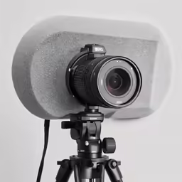 a tripod with a lens attached to it and on the back