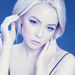 a woman with blue eyes posing for a photo