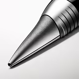 a metallic pen sits upon a white surface