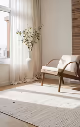 a white chair and a vase in front of a window