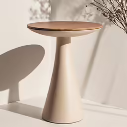 a minimal white vase sits on top of a wood table