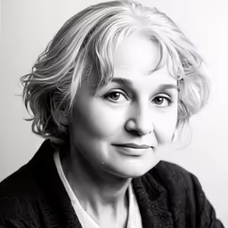 a woman with curly hair is looking into the camera