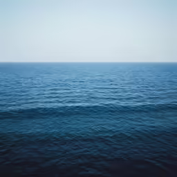 a view of the ocean from above of an airplane