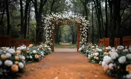 a garden archway covered in white flowers
