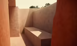 a wall next to a bench in a courtyard