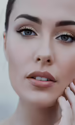 a woman wearing some makeup looking at the camera