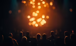 people looking at bright lights from stage
