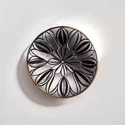 a black and white plate with a gold rim