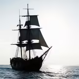 the tall ship is sailing in the open water