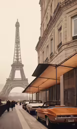 an antique car sits parked beside a tall building and a statue