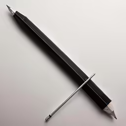 a pencil and pen on the table with a small pencil