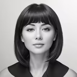 a woman wearing black and white in front of a white background