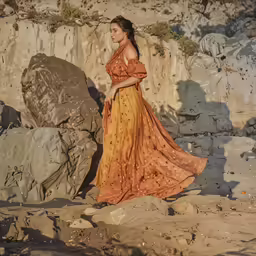 an image of a woman in a dress standing near a rock formation