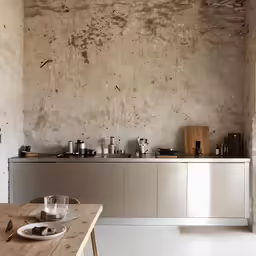 a large kitchen counter with utensils and bowls on it