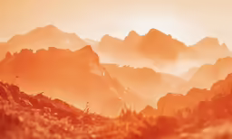 a view of the mountains and sky during sunset