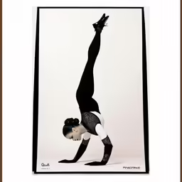 a woman standing on one leg with her hands in the air