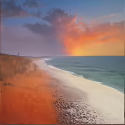 a red and blue sky over a beach and water